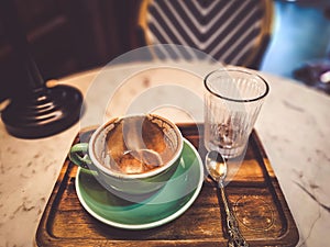 Hot cappuccino coffee in a drinking glass Placed on the table in a warm atmosphere. There is space for text