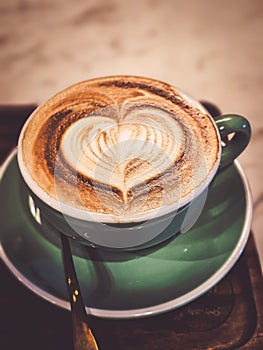 Hot cappuccino coffee in a mug Placed on the table in a warm atmosphere