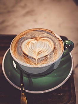 Hot cappuccino coffee in a mug Placed on the table in a warm atmosphere