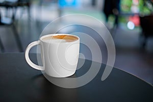 Hot cappuccino coffee in white mug cup