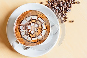 Hot cappuccino with nice milk pattern with coffee bean