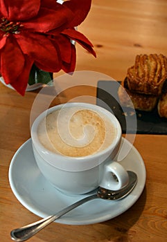 Hot cappuccino and small pizza on the table