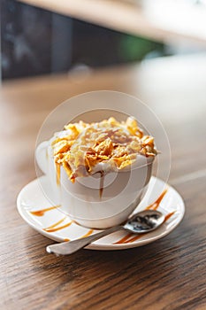 Hot cappuccino topping with corn flakes cereal and caramel butterscotch