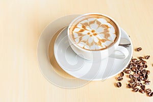 Hot cappuccino on wood table