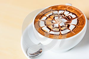 Hot cappuccino on wood table