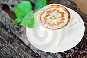 Hot cappuccino on wood table