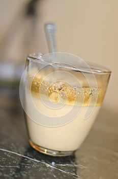 Hot cappucinno caffee foam into glass photo
