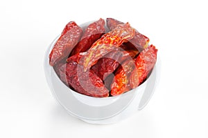 Hot chili peppers in a bowl on white background