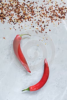 Hot chili peppers on grey marble background, crescent shaped. use for arabic sauce harissa, georgian sause adjika. Italian bio