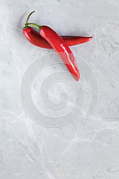 Hot chili peppers on grey marble background, use for arabic sauce harissa, georgian sause adjika. Italian bio peperoncino by