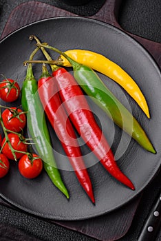 Hot chili peppers of three different colors red, green and yellow