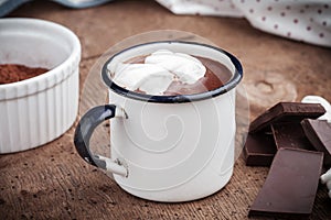 Hot chocolat with marshmallows on a rustic wooden table