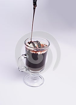 Hot chocolate and chocolate pieces isolated on white background