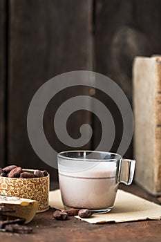 Hot Chocolate and chocolate pieces over rustic wooden background. Homemade Hot Chocolate Drink for Christmas and winter holidays