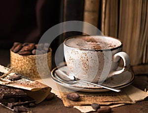 Hot Chocolate and chocolate pieces over rustic wooden background. Homemade Hot Chocolate Drink for Christmas and winter holidays