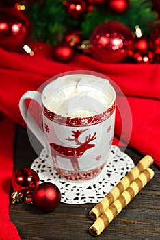 Hot chocolate or cocoa beverage with cinnamon and gingerbread cookies in snow vintage wooden table background.