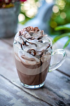 Hot chocolate cocoa in glass mug with whipped cream