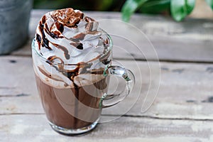 Hot chocolate cocoa in glass mug with whipped cream