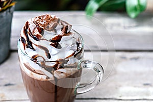 Hot chocolate cocoa in glass mug with whipped cream