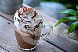 Hot chocolate cocoa in glass mug with whipped cream