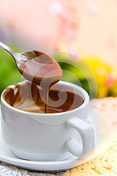 Hot chocolate cup on table at cafe outdoors summer. Coffee time and breakfast in restaurant. Chocolate, hot frothed milk