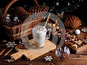 Hot chocolate drink with whipped cream. Cozy Christmas composition on a dark wooden background. Sweet treats for cold