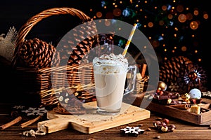 Hot chocolate drink with whipped cream. Cozy Christmas composition on a dark wooden background. Sweet treats for cold winter days.