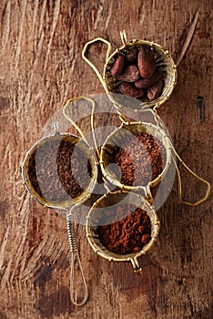 Hot chocolate flakes, grated chocolate, powder and cocoa beans i