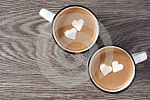 Hot chocolate with heart marshmallows over wood