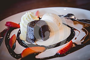 Hot chocolate lava cake with vanilla ice cream and fresh strawberry