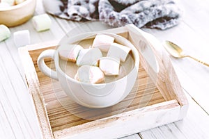 Hot chocolate and marshmallow on wooden background