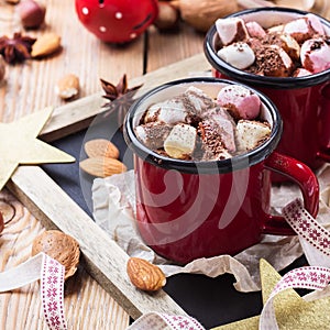 Hot chocolate with marshmallows and spices on christmas table