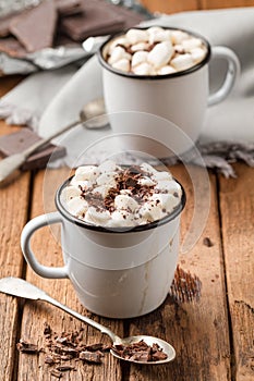 Hot chocolate with marshmallows in two enamel tin mugs