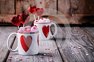 Hot chocolate with pink marshmallow in mugs with hearts for Valentine day