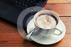 Hot chocolate is served with hot bread between the notebook.