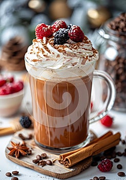 Hot chocolate with whipped cream fresh berries and cinnamon in glass mug on wooden background. Christmas drink