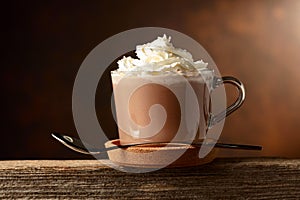 Hot chocolate with whipped cream in a glass mug