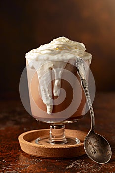 Hot chocolate with whipped cream in a glass mug