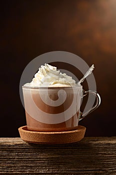 Hot chocolate with whipped cream in a glass mug
