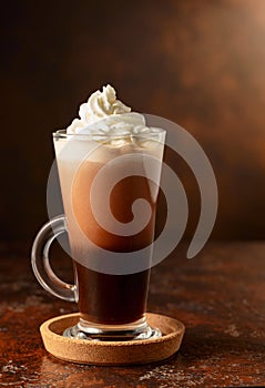 Hot chocolate with whipped cream in a glass mug