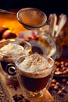 Hot chocolate with whipped cream sprinkled with cinnamon