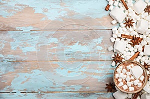Hot Chocolate, White Marshmallows and Winter Spices on Blue Wooden Background