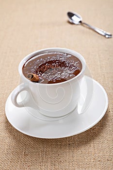 Hot chocolate in white mug, saucer and spoon