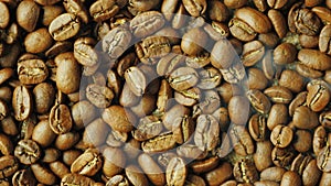 Hot choicest Arabica beans, rotate. Above them, a wisp of smoke
