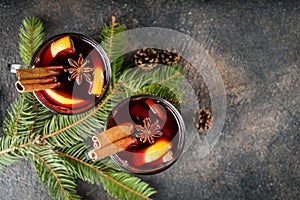 Hot Christmas drink on a dark background with a fir branch copy space