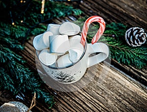 hot Christmas drink with marshmallow on wooden table