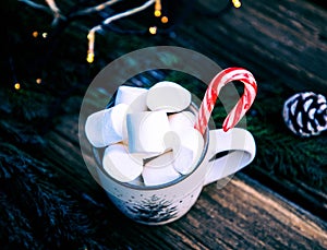 hot Christmas drink with marshmallow on wooden table