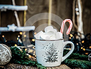 hot Christmas drink with marshmallow on wooden table