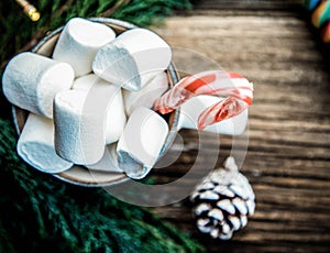 hot Christmas drink with marshmallow on wooden table