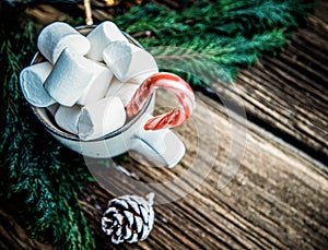 hot Christmas drink with marshmallow on wooden table